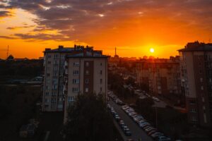 city buildings sunset clouds parking 4k 1538066682