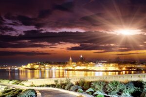 evening sunset sun clouds city landscape track buildings skyline 4k 1538067185