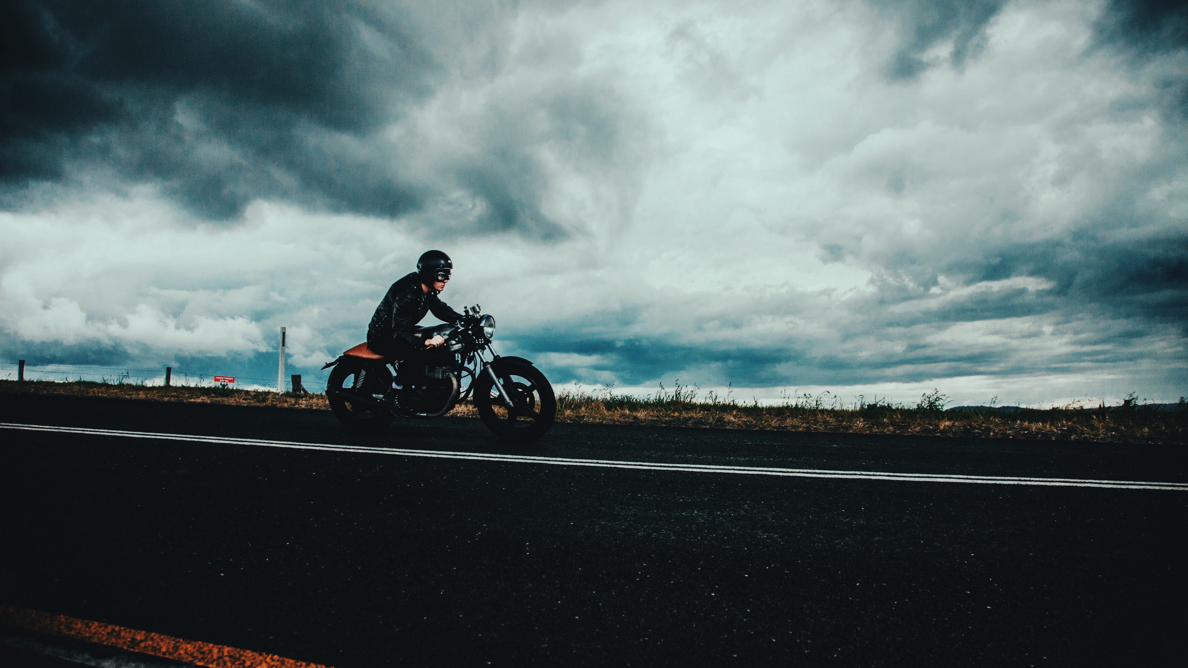 motorcyclist road marking asphalt helmet clouds overcast 4k 1536018421