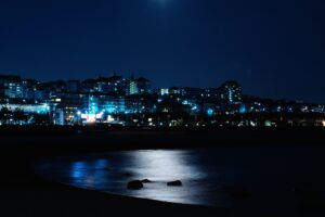 night city night buildings sea shore 4k 1538067076