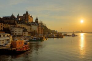 sweden stockholm promenade river sun track sunrise fog gold houses towers water boat reflection sky 4k 1538067603