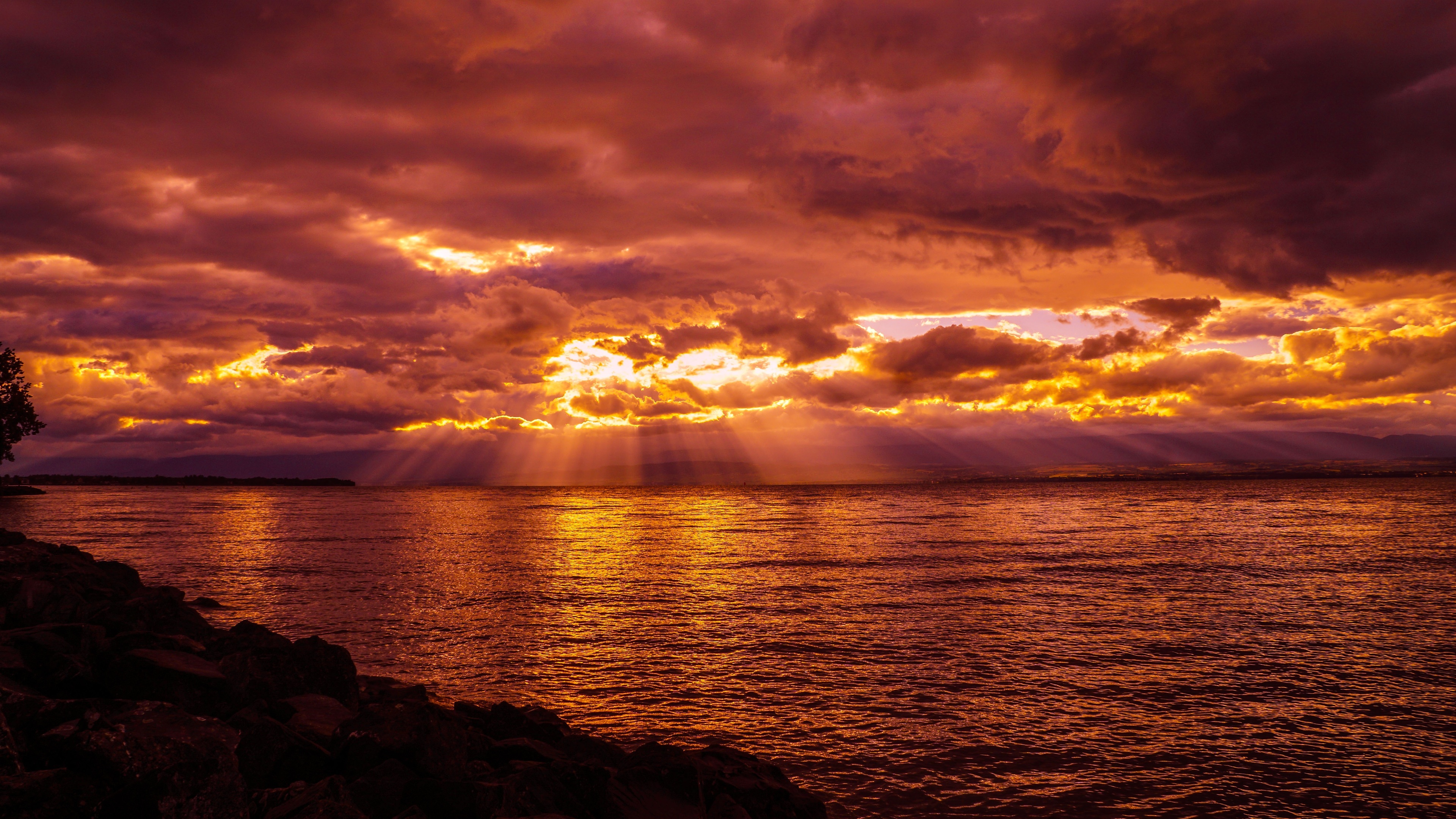 crepuscular rays lake sunset sea 4k 1540134129