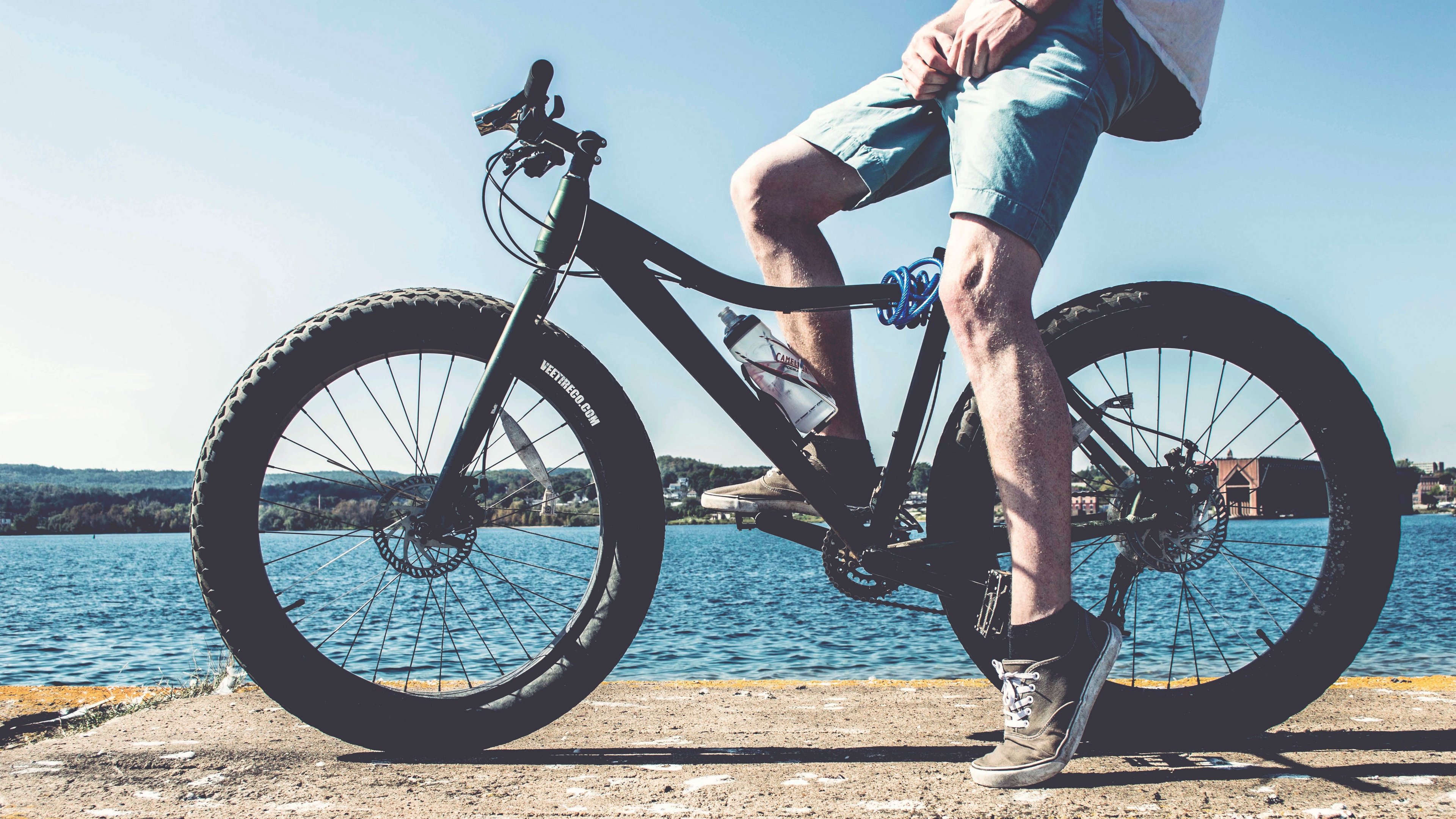 cyclist legs bicycle river 4k 1540062350