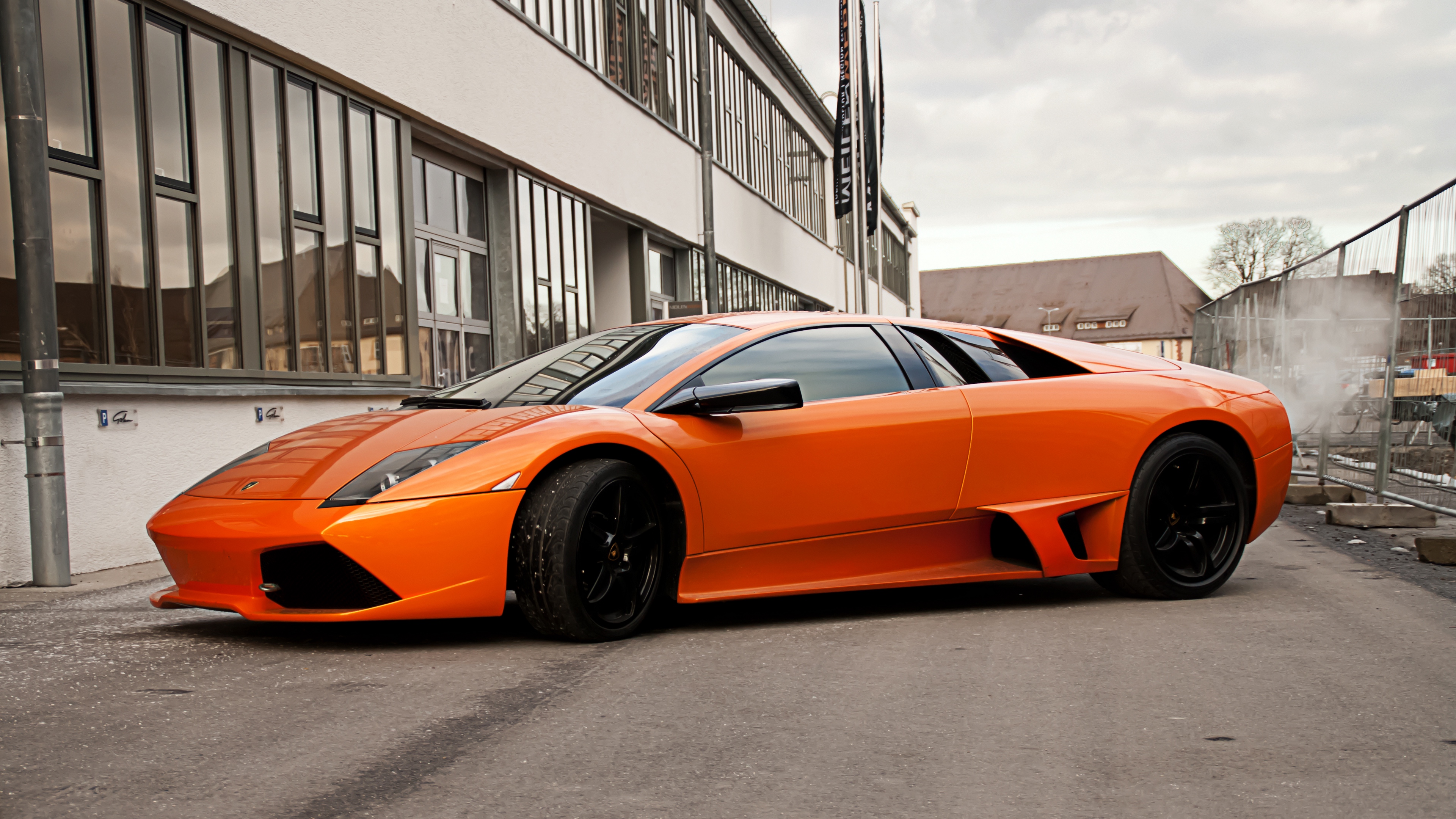 lamborghini murcielago lp640 orange side view black wheels building windows fence sky clouds 4k 1538935534