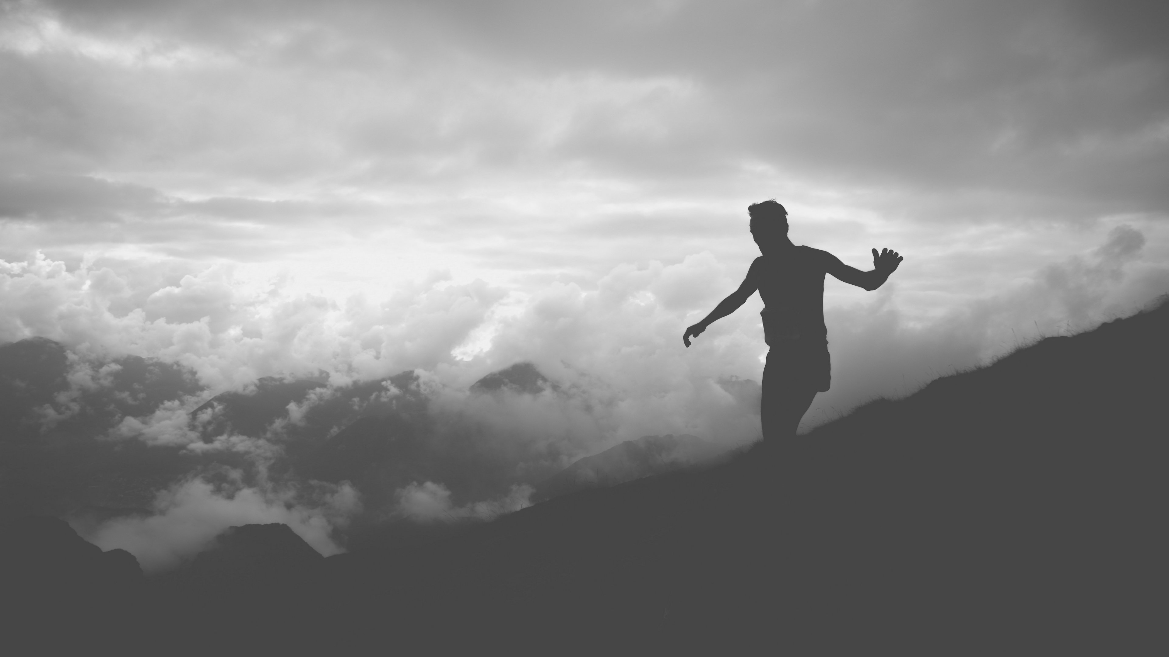 man silhouette clouds mountains bw 4k 1540574693