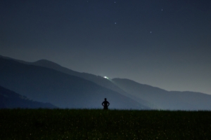 man silhouette field night sky stars 4k 1540576401