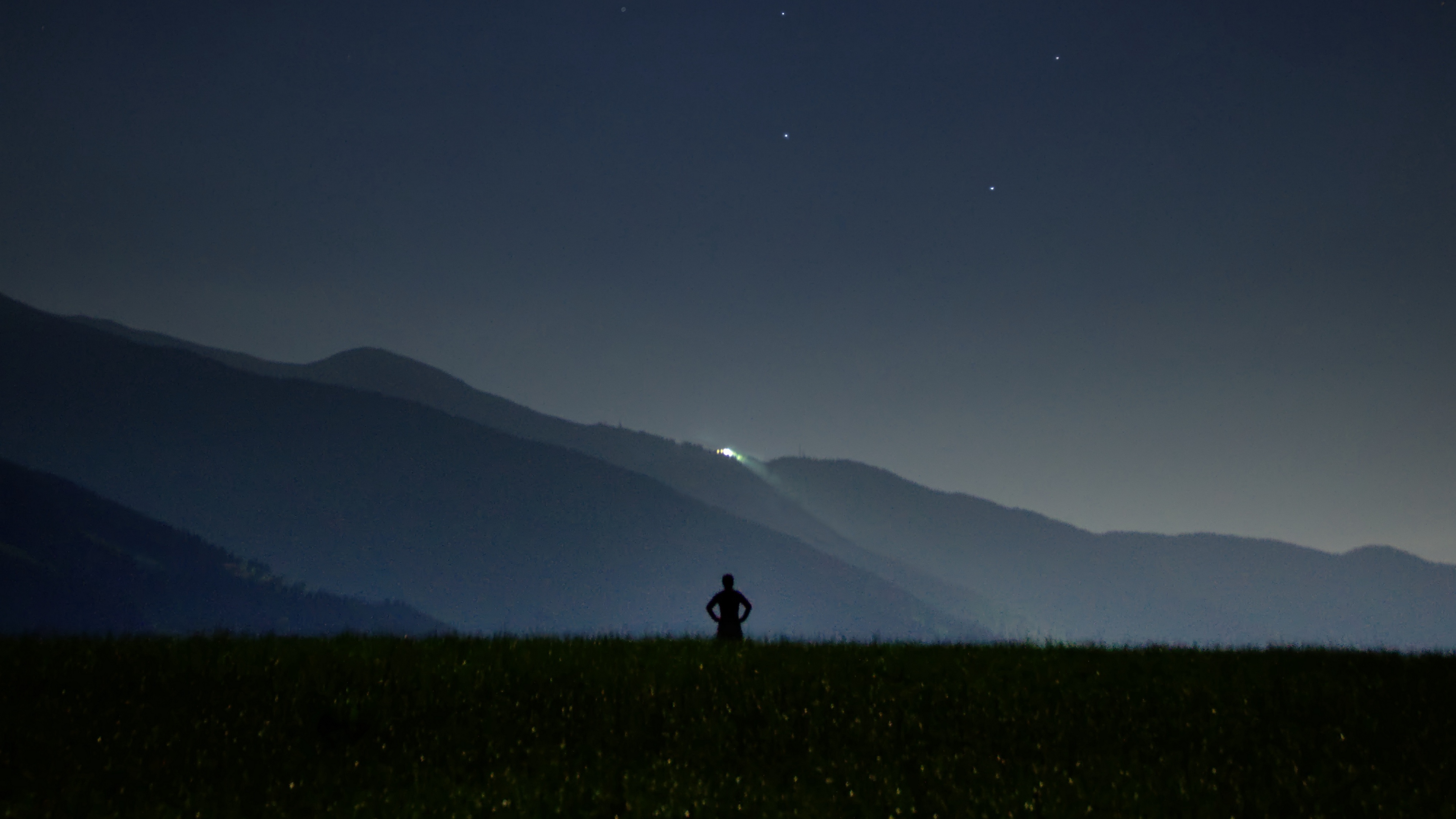 man silhouette field night sky stars 4k 1540576401