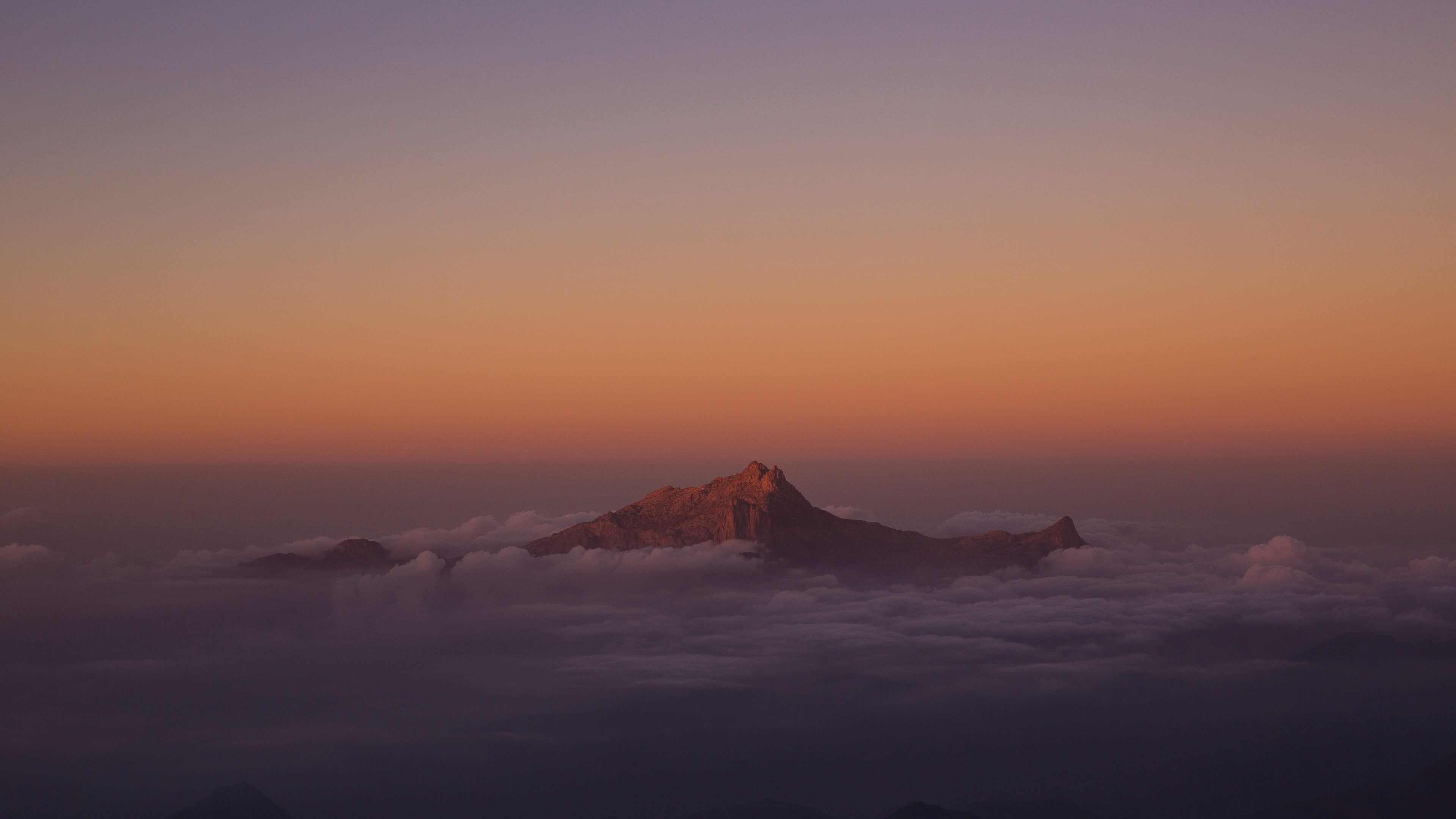 mountain peak from clouds 5k 1540142974