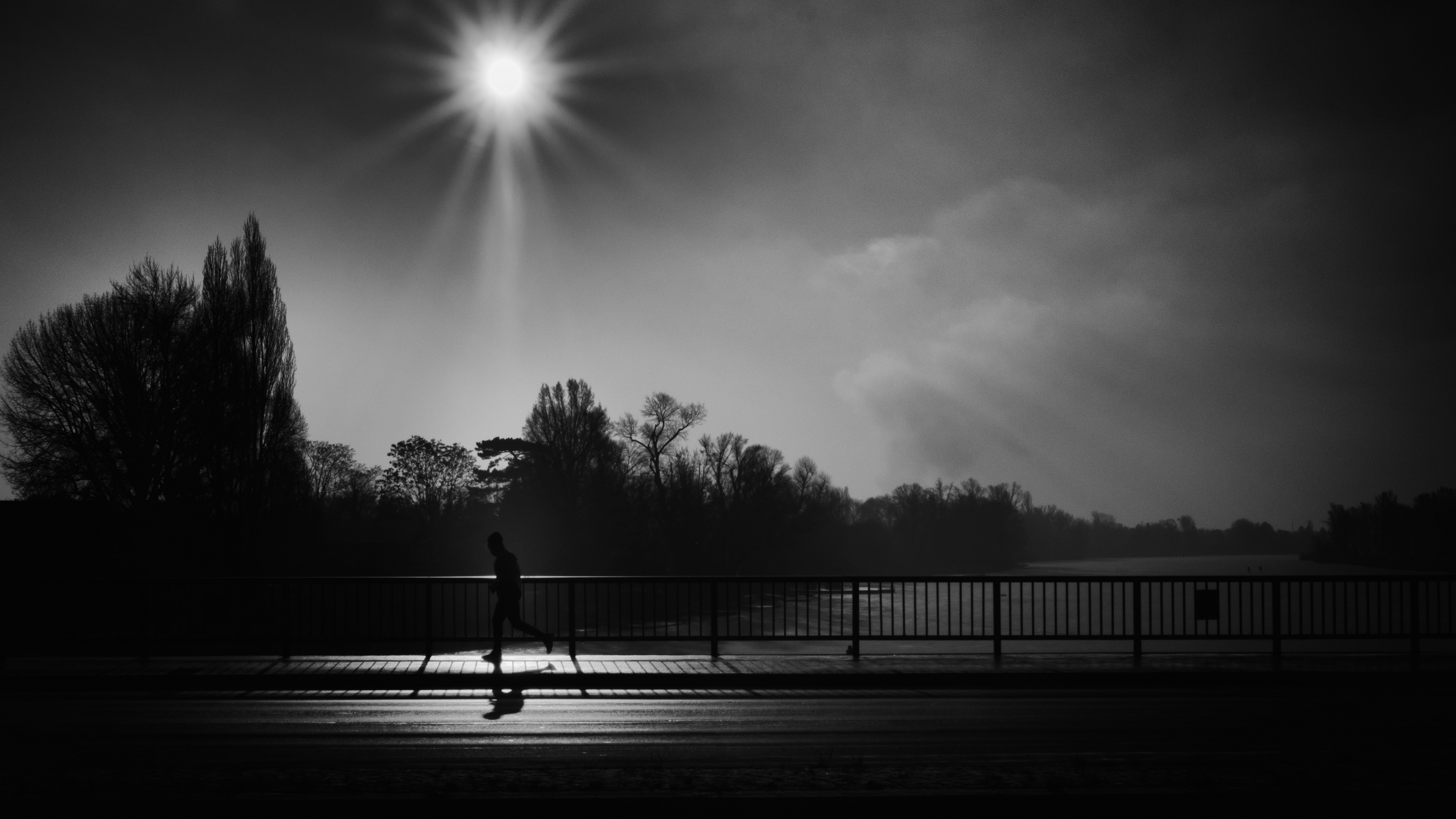 silhouette running bridge bw sunlight 4k 1540575944