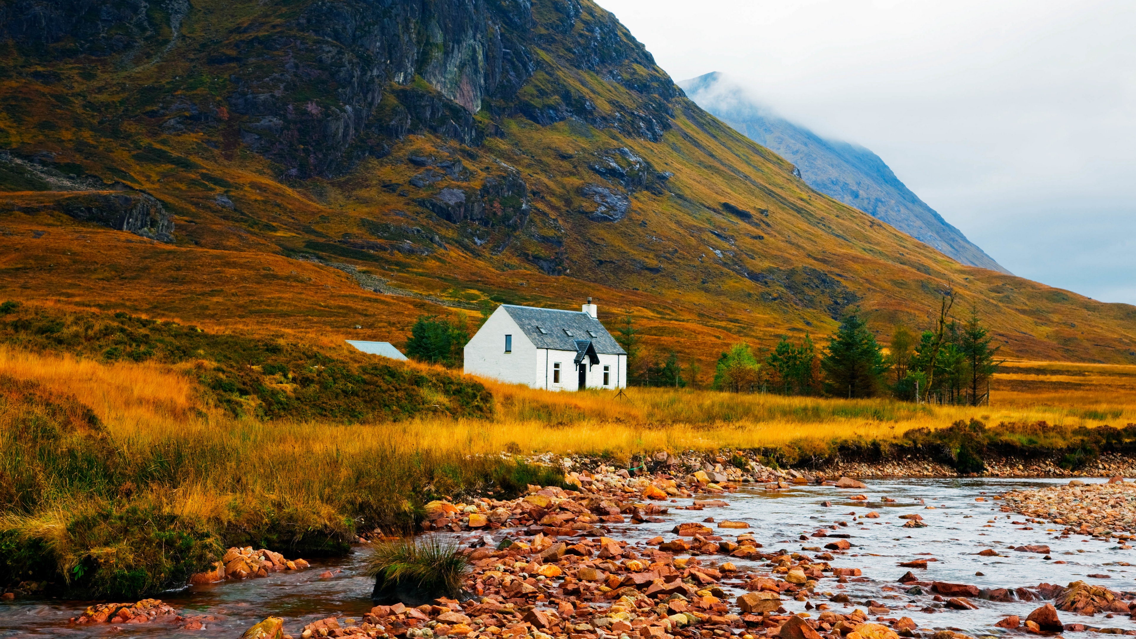 house lake stones grass mountains 4k 1541117613