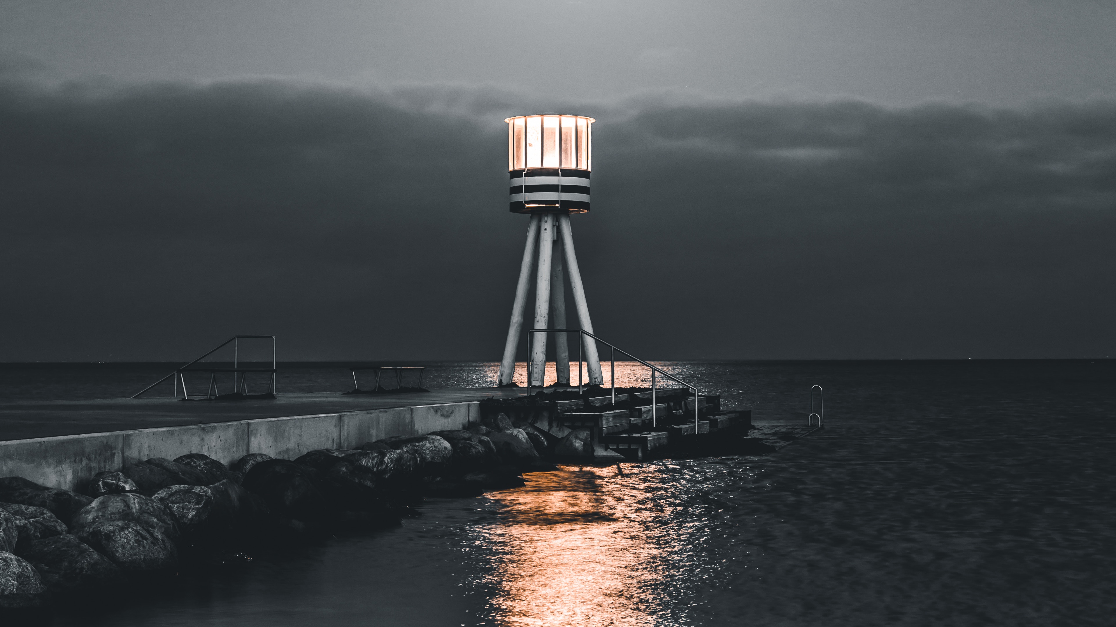 lighthouse sea pier night stones water 4k 1541116676