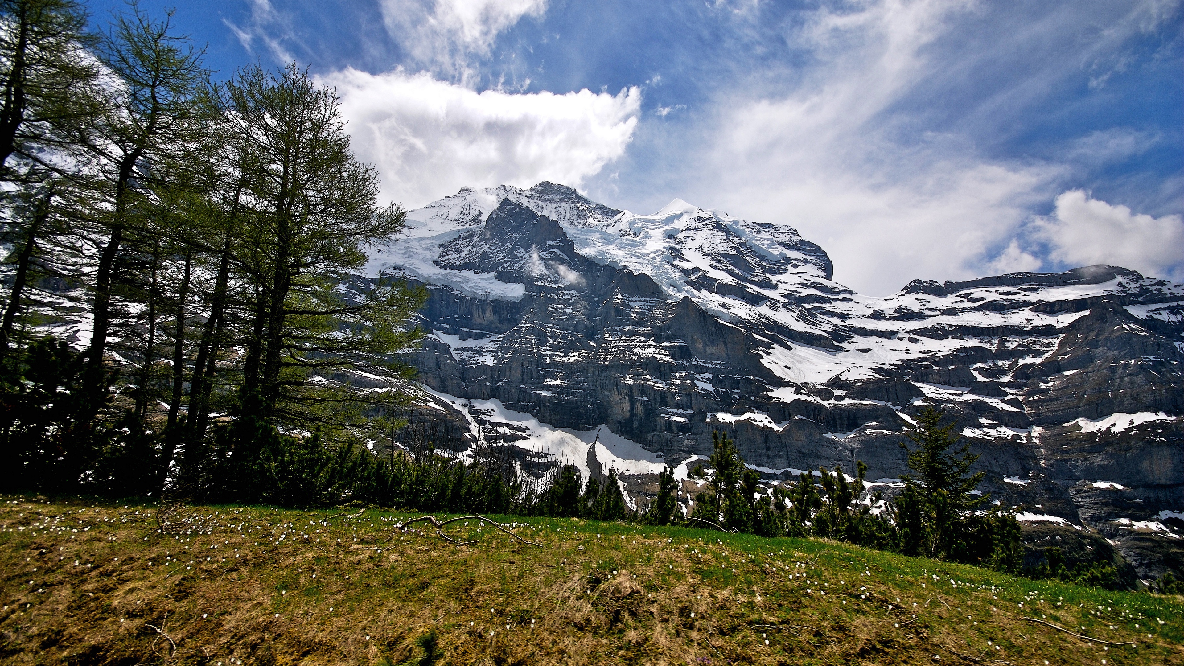 mountains grass top sky 4k 1541117554