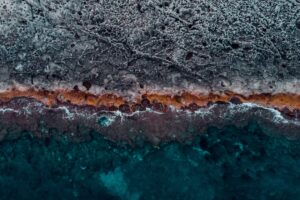 ocean coast aerial view water stones surface ribbed 4k 1541113732