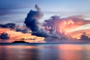 sea clouds horizon island sky sunset 4k 1541117907