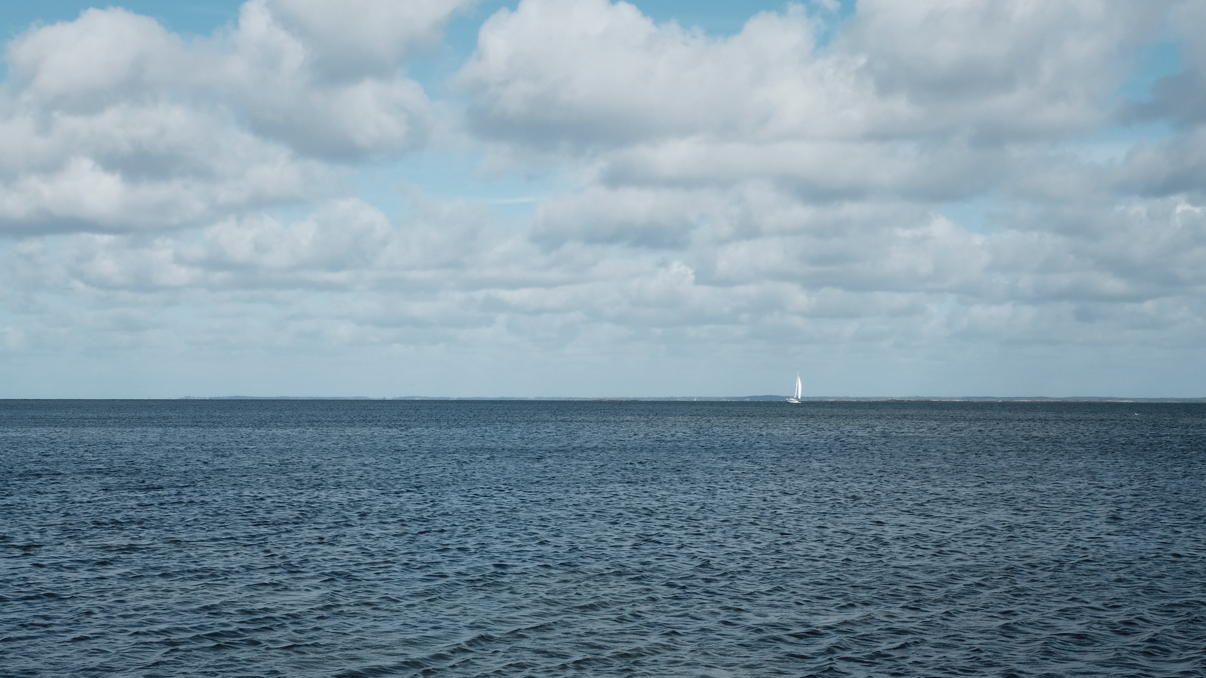 sea skyline boat clouds sky ripples 4k 1541115573