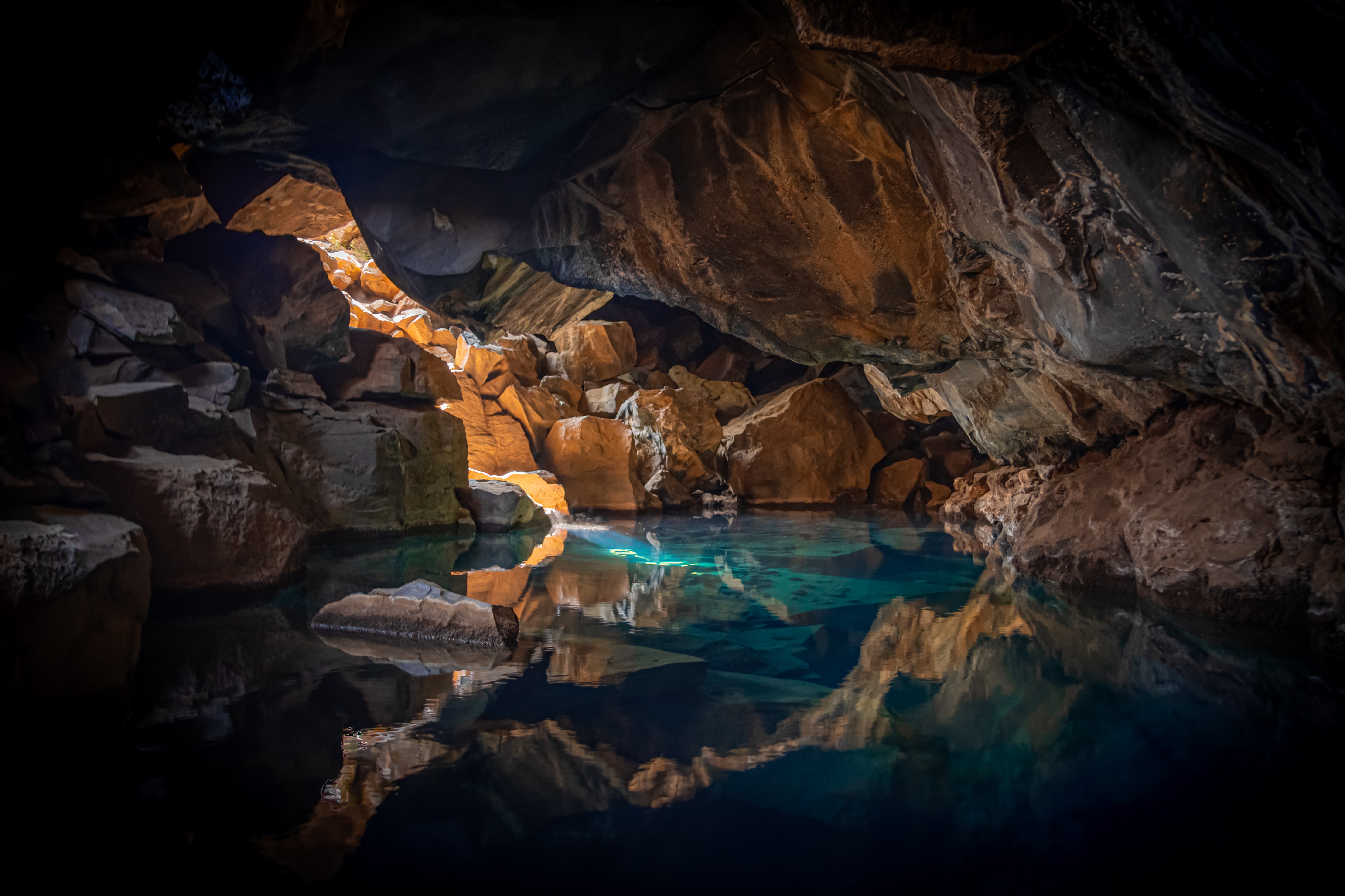 iceland cave surrouned with blue body of water 1574937754