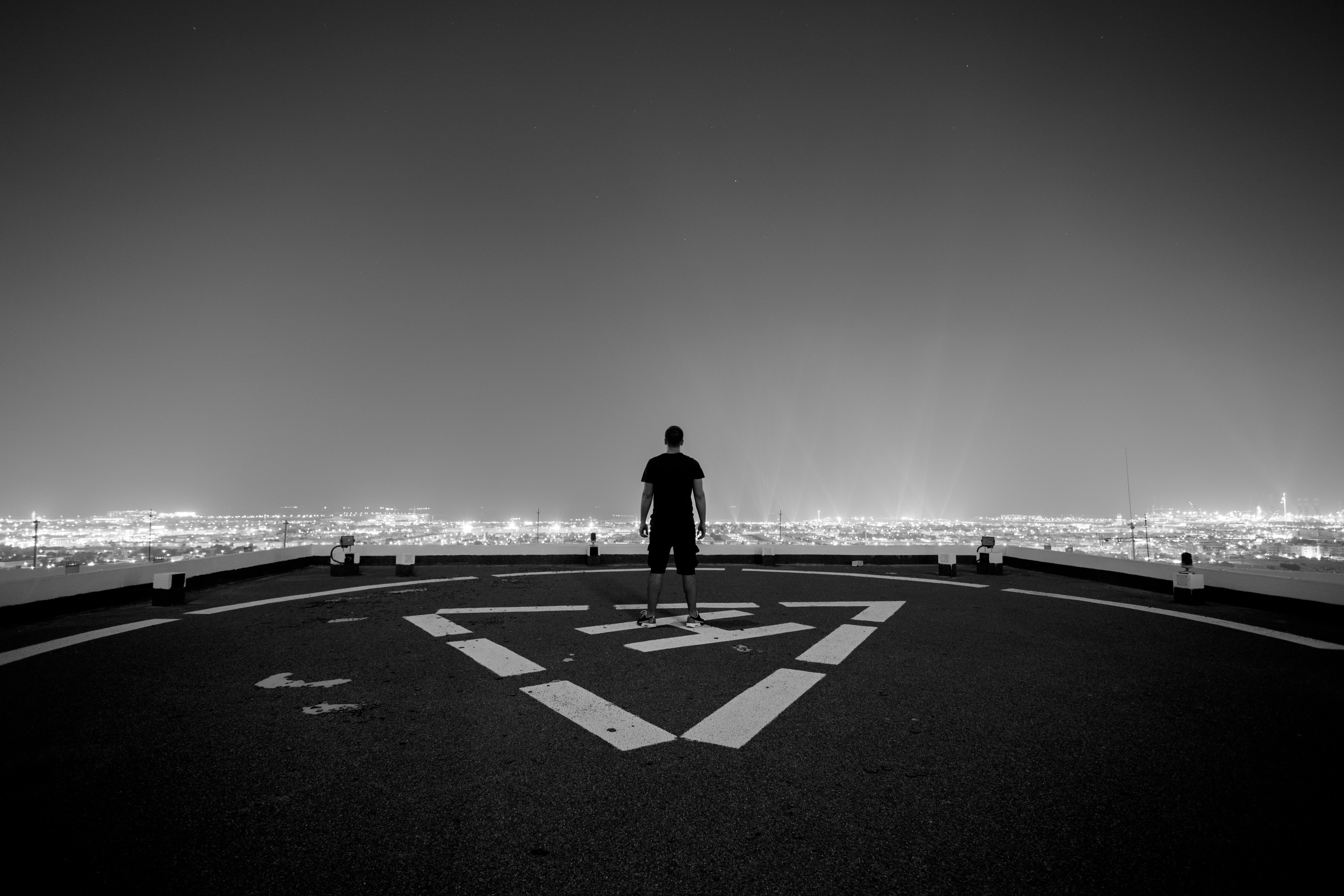 man standing helipad monochrome 1574938445