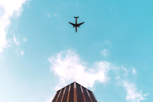 plane flying over building 1574939148