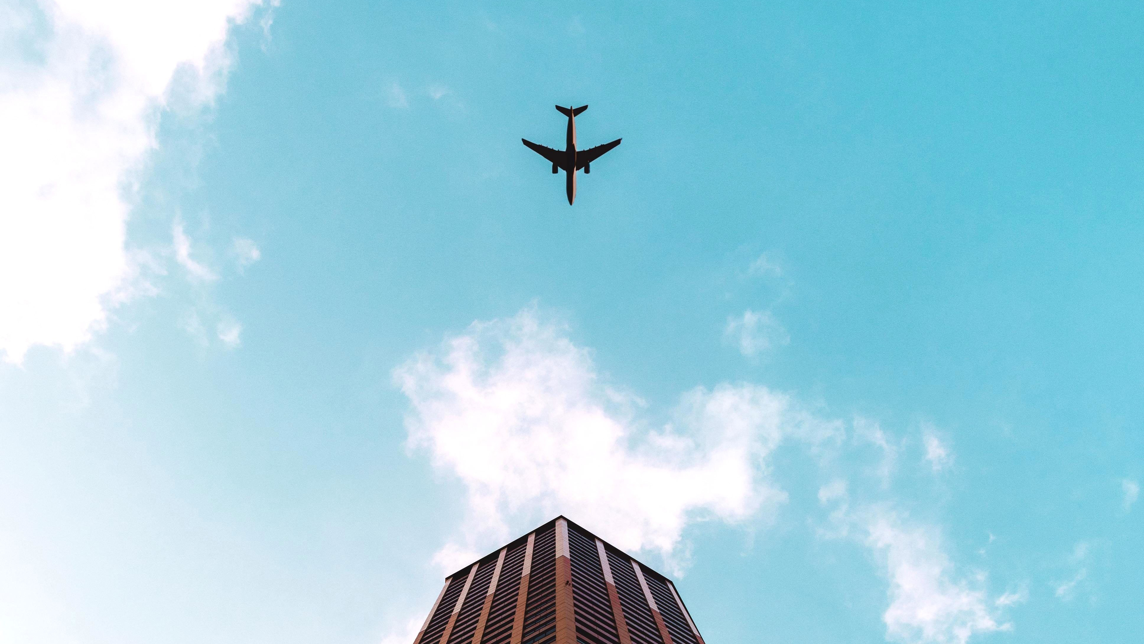 plane flying over building 1574939148