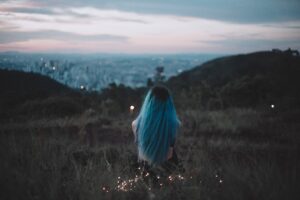 blue hair sitting on grass field back view 1575665462