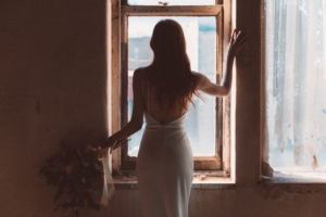 bride standing at the window 1575665119