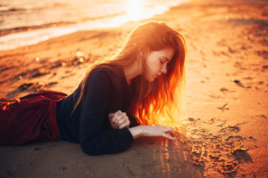 girl beach playing with sand 1575665951