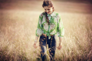 girl in field walking smiling 1575666211