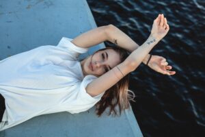 girl in white shirt lying down 1575665758