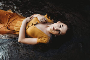 girl lying down orange dress 1575665734