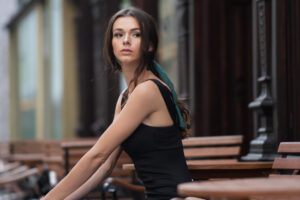 girl outdoor sitting on a bench looking away 1575665886