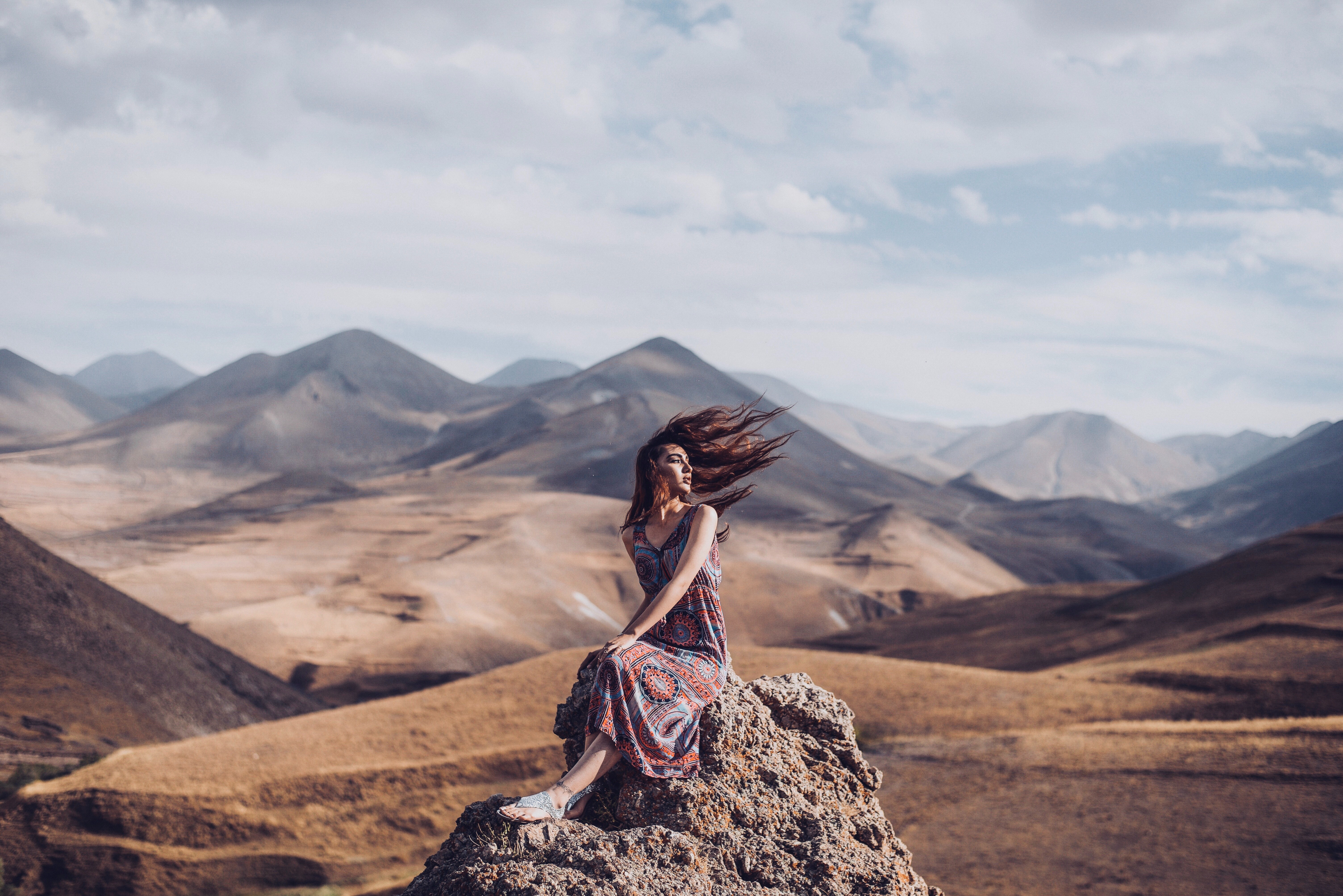 girl sitting on rock hairs in air 1575664165