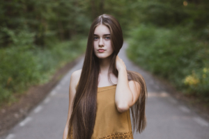 girl standing on road path 1575664534