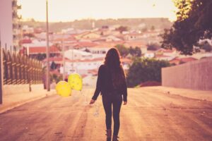 girl with balloon walking away 1575665489