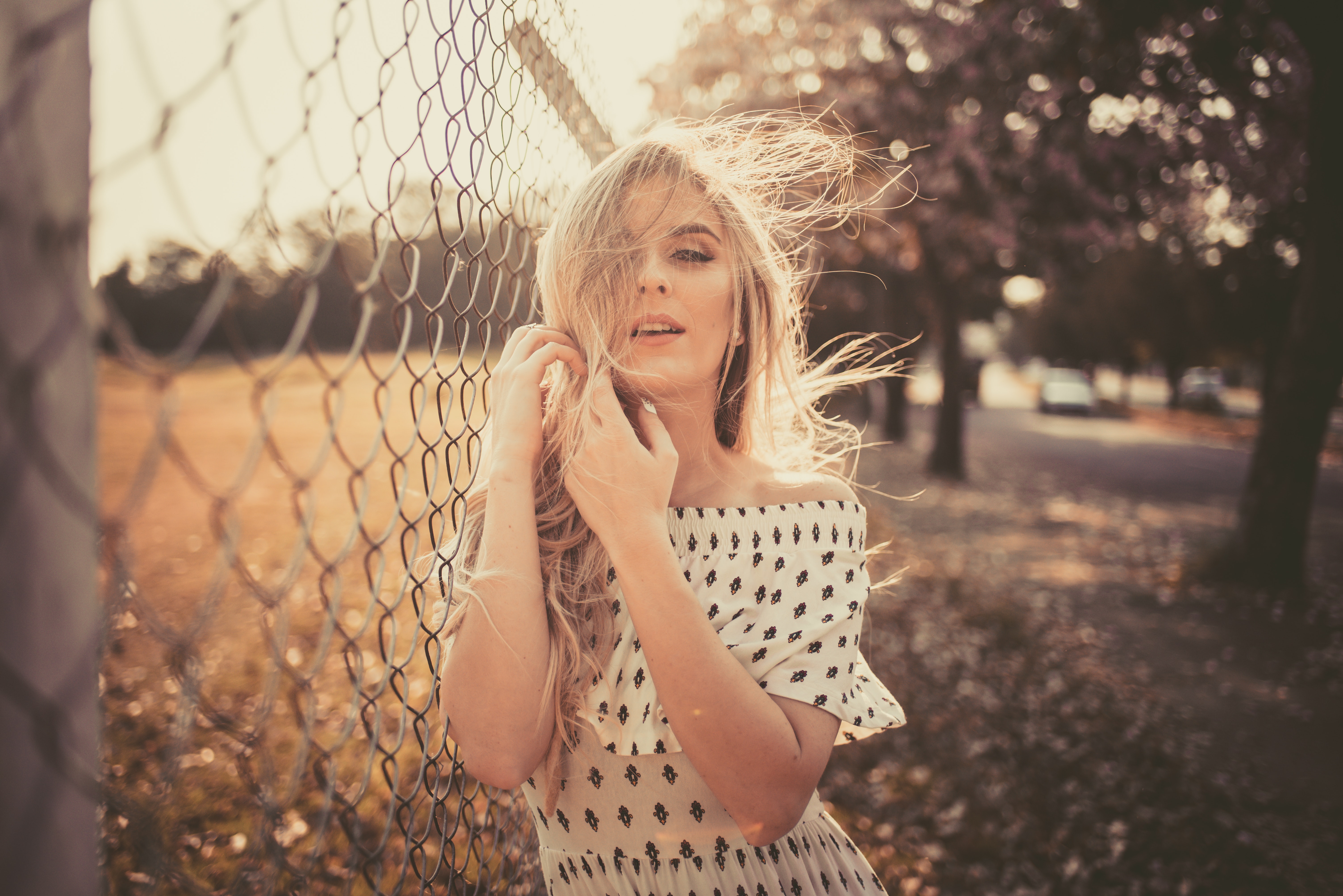 woman leaning on chain fence 1575664765