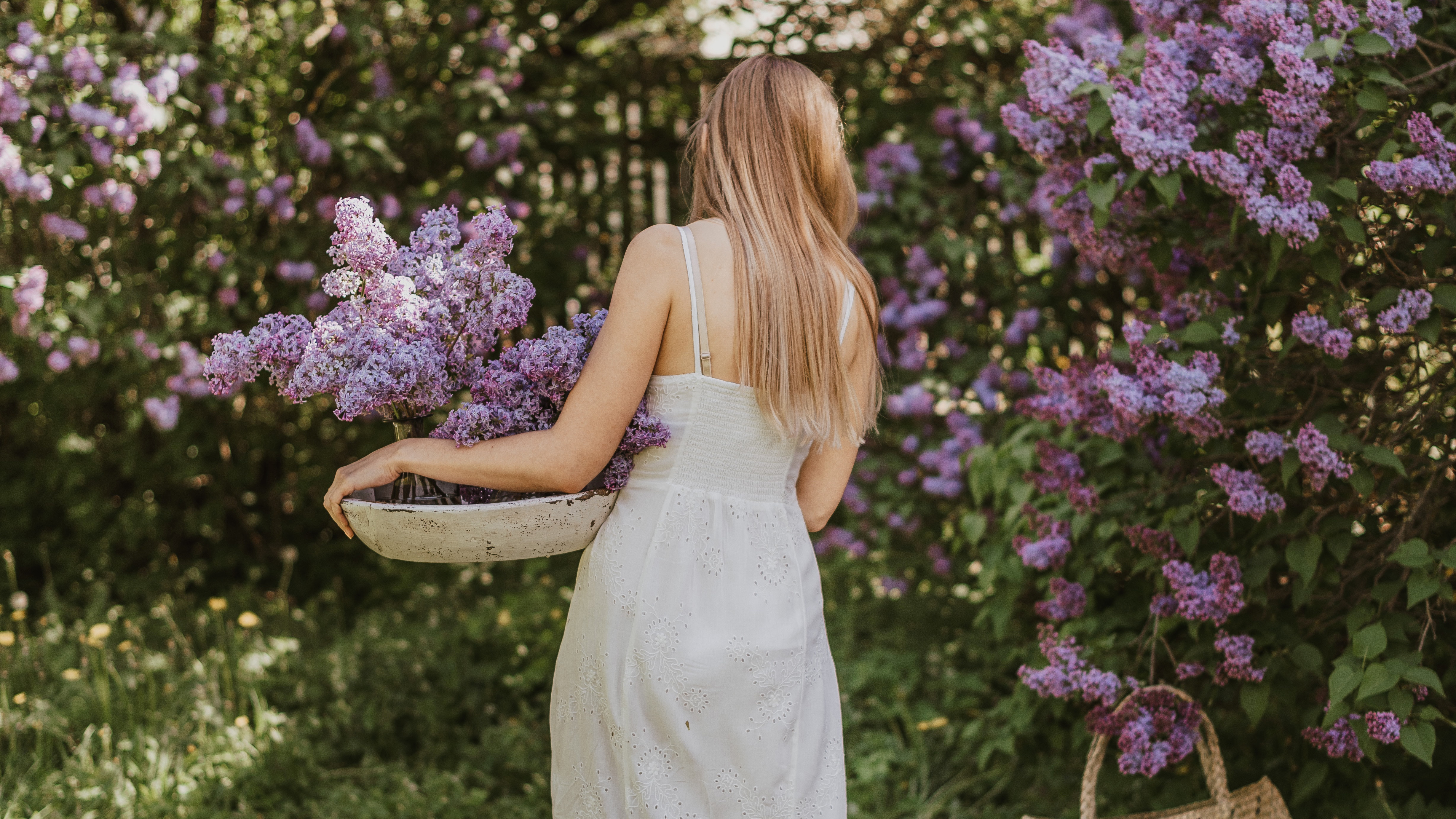 women in white dress collecting flowers 1575666050