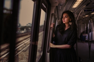 women standing in train holding metal rail while looking outside 1575665254