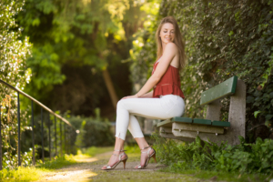 young beautiful girl sitting on bench 1575665478