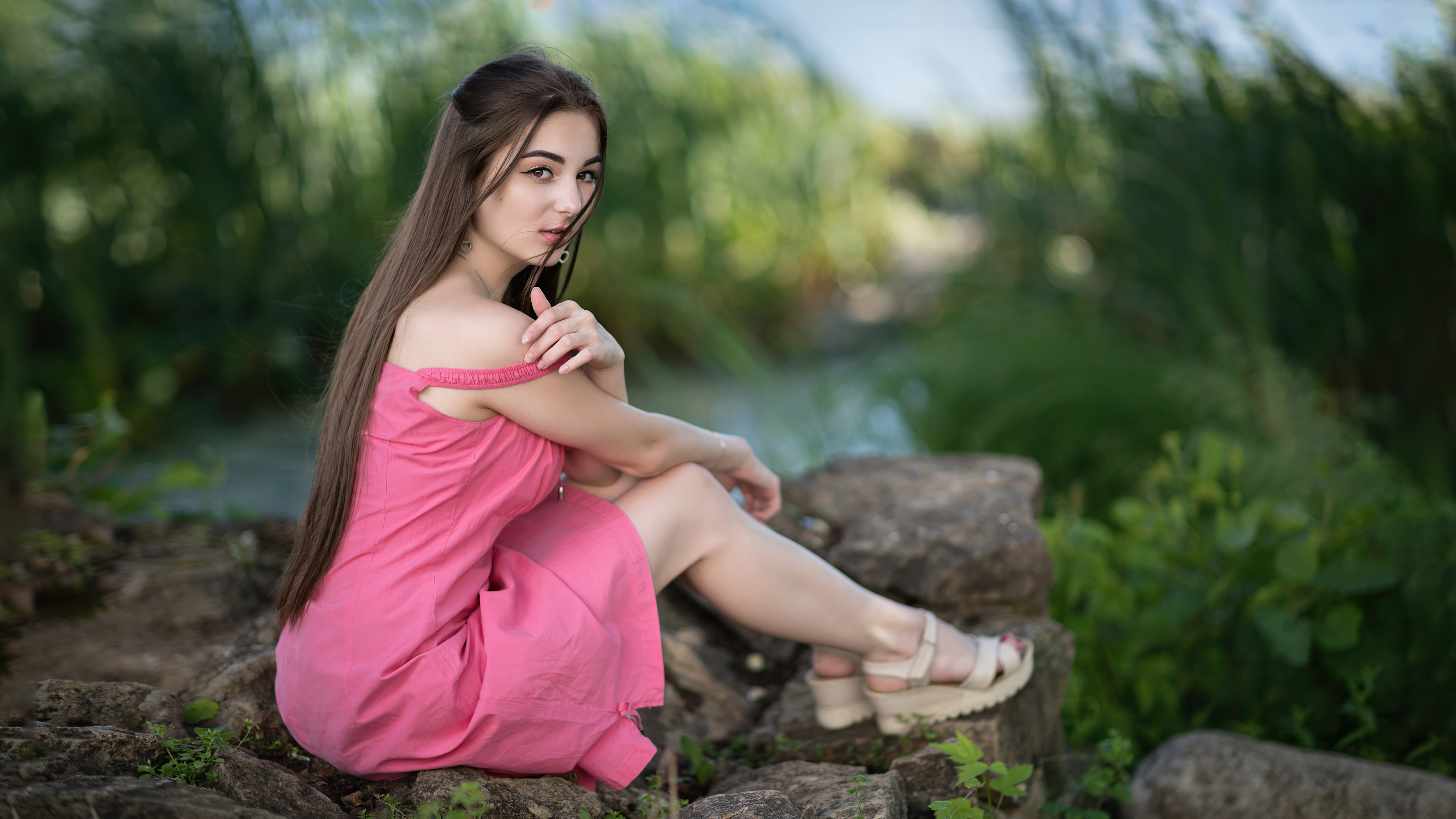 cute girl sitting on rock in pink dress looking at viewer 4k 1629241298