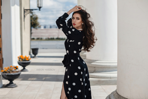 hands in hair looking back polka dot black dress 4k 1639250184