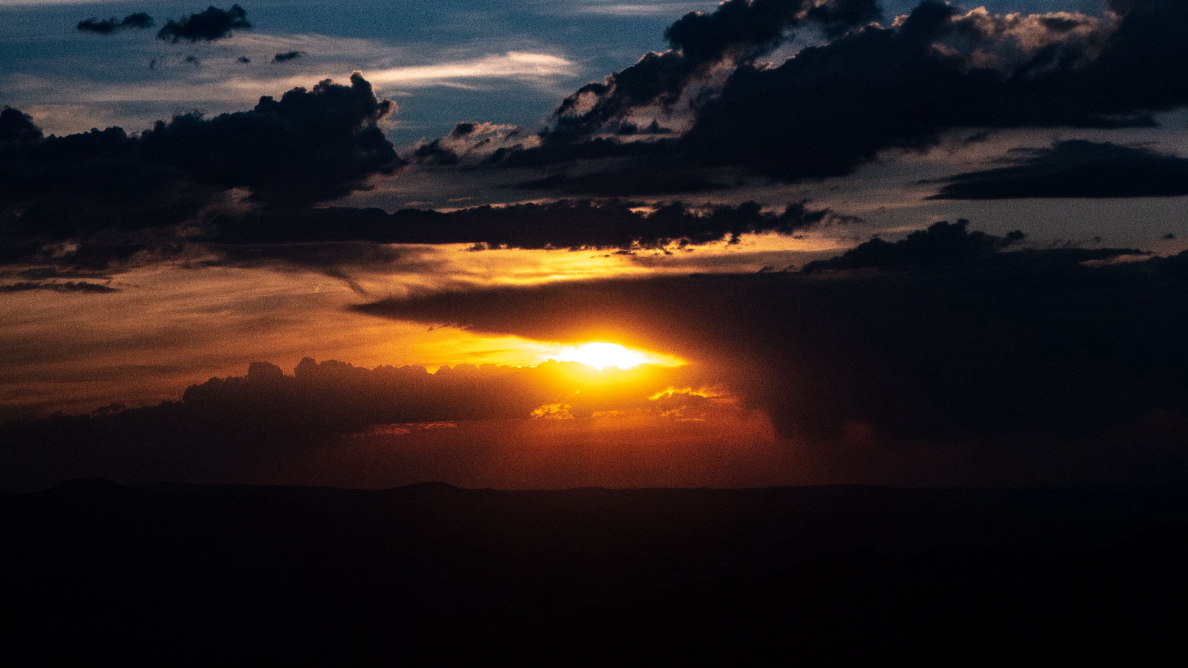 sunset clouds sun twilight dark 4k 1692006750